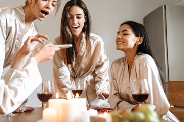 Cheerful pretty girfriends wearing dressing gowns