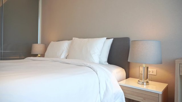Pan across a resort hotel suite and bed.
