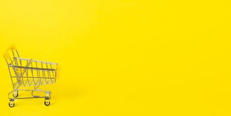 Banner: small shopping cart on yellow background. Space for text