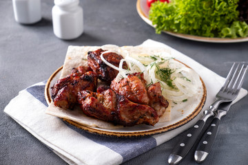 Tasty grilled meat with onionon a plate. Kebabs