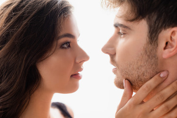 side view of woman and man looking at each other isolated on white