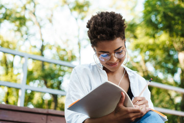 Concentrated african woman reading book