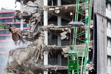 Demolition of a building with an excavator in Rotterdam in the Netherlands