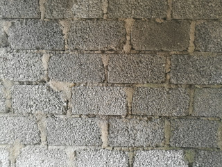 A Wall made of cement blocks and concrete like texture.