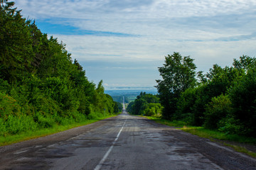 Fototapeta na wymiar asphalt road with a mountain landscape in the background