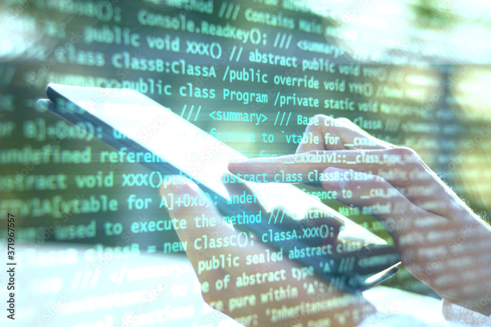 Aufkleber Hand using digital tablet and abstract coding text interface on screen.