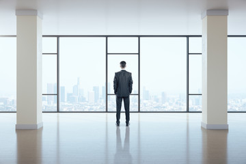 Fototapeta premium Businessman standing in gallery interior