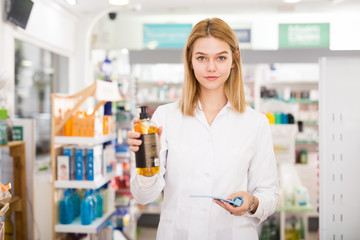 Portrait of friendly laughing pharmacist working in modern farmacy. High quality photo