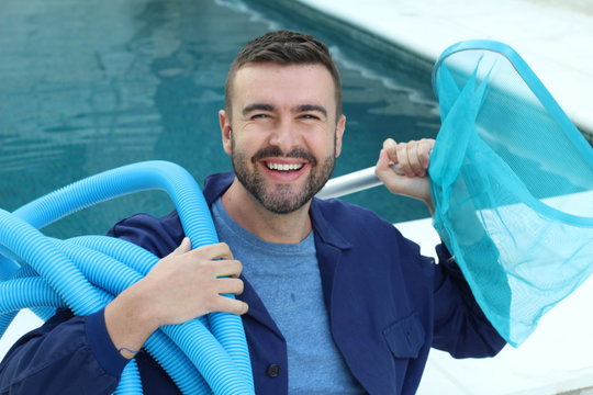 Hotel employee cleaning swimming pool 