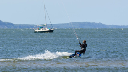 Naklejka premium KITESURFER - Active recreation on the water during a seaside holiday 