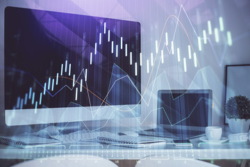 Financial graph colorful drawing and table with computer on background. Multi exposure. Concept of international markets.