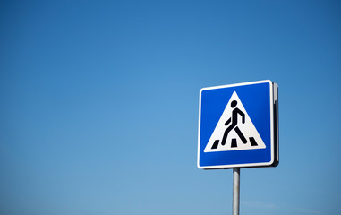 Road sign Pedestrian crossing on a background of blue sky