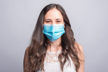 close up portrait of young woman wearing medicinal mask.