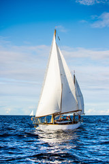Old expensive vintage wooden sailboat (yawl) close-up, sailing in an open sea. Coast of Maine, US. Sport, cruise, recreation, leisure activity © Alex Stemmer
