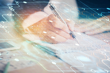 Double exposure of writing hand on background with data technology hologram. Big data concept.