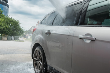 hand  washes away active foams and a water jet under high pressure with car