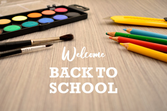 Welcome Back to School stock images. Art supplies on a wooden background. School supplies for painting. Back to School inscription with art tools on the table images