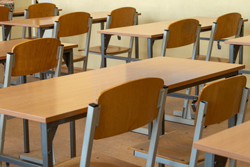 Interior of a school class. School empty classroom with desks and chair 