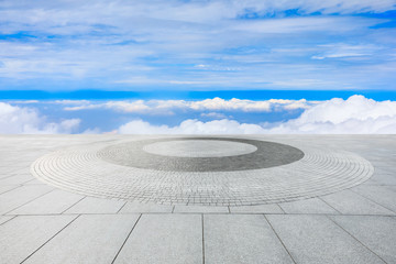 Empty square floor and blue sky with white clouds scene.