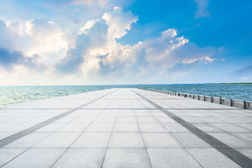 Empty square floor and lake with beautiful clouds.