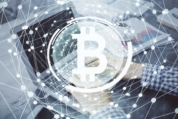 Blockchain theme hologram with man working on computer on background. Concept of crypto chain. Double exposure.