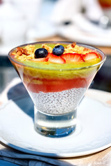 Chia pouding with fruits on a glass on a restaurant table