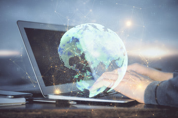 Fototapeta premium Social network theme hologram with businessman working on computer on background. Concept of world wide web. Multi exposure.