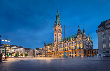 Hamburg, Germany. View of illuminated Town Hall building at dusk located on Rathausmarkt square