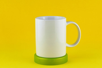Yellow background front view, in white porcelain cup holder as close-up