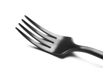 Modern black steel fork isolated on a white background. Close up.