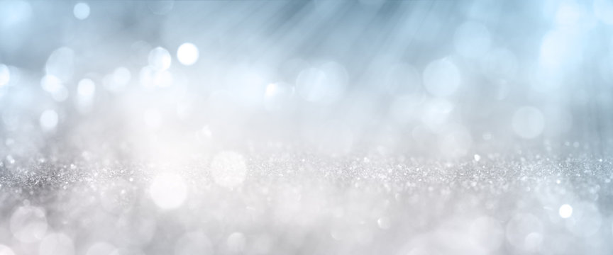 Bokeh effects on silver glittering background
White bokeh effects on blue and silver glittering abstract background with rays of light. Background for wedding and christmas. Space for design and text.