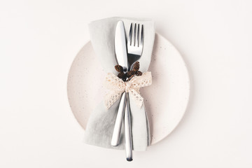 Beautiful set of cutlery knife and fork on a plate on a white wooden table. Concept of...