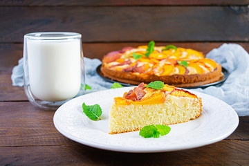 Delicious homemade peach pie on wooden background