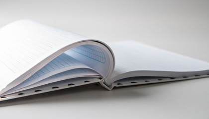 An expanded notebook for notes. Selective focus. Blurred background.