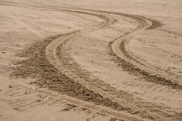 Car tire trail on a sand. Abstract background.