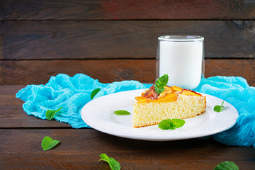 Delicious homemade peach pie on wooden background