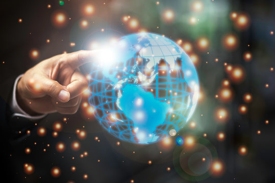Businessman hand touching at the globe. Science and technology Concept.