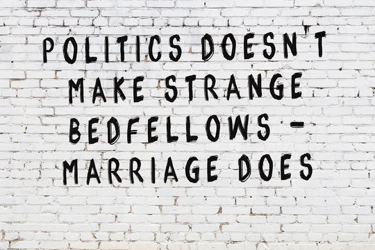 Black painted inscription of smart quote on white brick wall