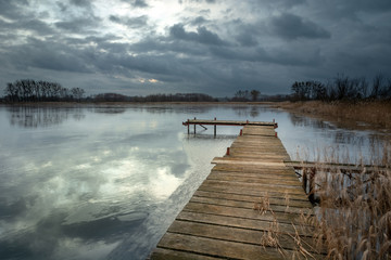 Wooden bridge in a frozen lake, Stankow, Lubelskie voivodeship, Poland