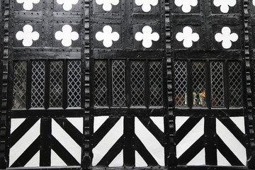 A closeup black and white pattern on a half timbered Tudor house in England.
