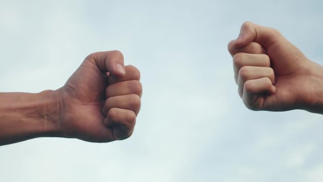teamwork concept. fist to fist commit solidarity a respect and brotherhood gesture. business team hands lifestyle fists close-up. people of different skin colors partnership friendship teamwork