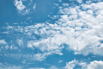 Beautiful blue sky with with light puffy cirrus clouds background