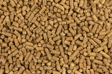 Brown wood pellets texture background. natural pile of wood pellets. organic biofuels. Alternative biofuel from sawdust. The cat litter. pile of compressed wood pellets.