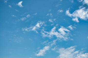 Beautiful blue sky with with light puffy cirrus clouds background