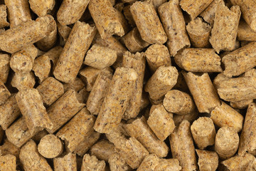 Brown wood pellets texture background. natural pile of wood pellets. organic biofuels. Alternative biofuel from sawdust. The cat litter. pile of compressed wood pellets.