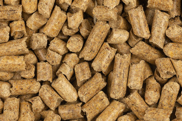 Brown wood pellets texture background. natural pile of wood pellets. organic biofuels. Alternative biofuel from sawdust. The cat litter. pile of compressed wood pellets.