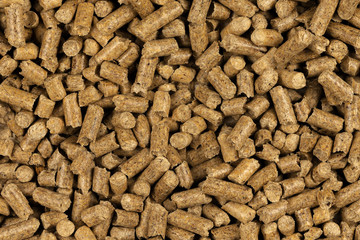 Brown wood pellets texture background. natural pile of wood pellets. organic biofuels. Alternative biofuel from sawdust. The cat litter. pile of compressed wood pellets.