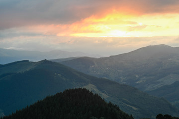 Sunset from Mount Ubieta, with the sun through the clouds