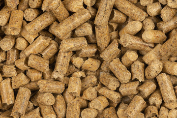 Brown wood pellets texture background. natural pile of wood pellets. organic biofuels. Alternative biofuel from sawdust. The cat litter. pile of compressed wood pellets.