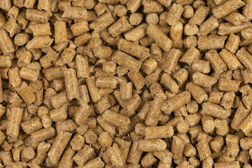 Brown wood pellets texture background. natural pile of wood pellets. organic biofuels. Alternative biofuel from sawdust. The cat litter. pile of compressed wood pellets.